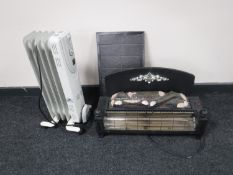 A log effect electric fire with hearth and an oil filled radiator