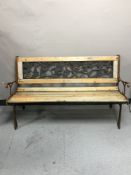 A cast metal and wood garden bench