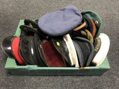 A box of a collection of military caps and berets