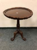 A reproduction mahogany pedestal occasional table