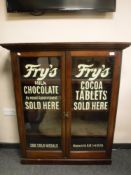 A Victorian and later glazed mahogany bookcase with later advertising writing,