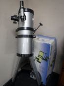 An Astronomical telescope on stand with box