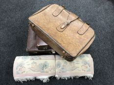 A pink Chinese rug and three vintage luggage cases
