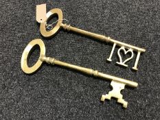 Two oversized brass keys