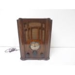Vintage Ferguson valve radio in mahogany case with Bakelite knobs and glass dial.
