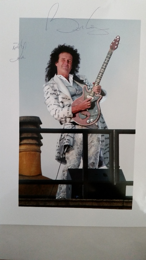 POP MUSIC, signed colour photo by Brian May, full-length playing guitar on roof of Buckingham