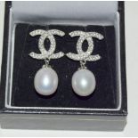 Pair of silver Chanel style earrings with pearl drops