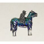 Silver and plique a jour brooch in the form of a jockey and horse