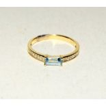 14ct yellow gold blue topaz and white sapphire ring. Size N