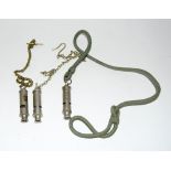 Two Police whistles on chains and a City Police or Fire whistle on a cord lanyard