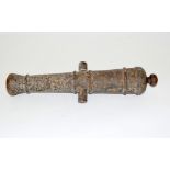 A cast iron cannon barrel 50cms long by 14cms across the trunnions