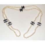 Long string of freshwater pearls with Chanel style spacers