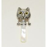 silver baby's rattle in the form of a cat with glass eyes