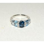 14ct white gold ring with central tourmaline and diamond flanked blue topaz. Size N