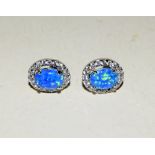 Pair of silver CZ and blue opal stud earrings