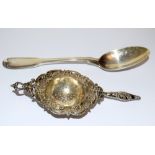 A silver spoon and a tea strainer