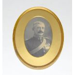 A gilt framed portrait photograph of a Victorian Worcestershire Regiment officer in uniform with his