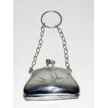 White meatl leather lined purse engraved with a swallow.