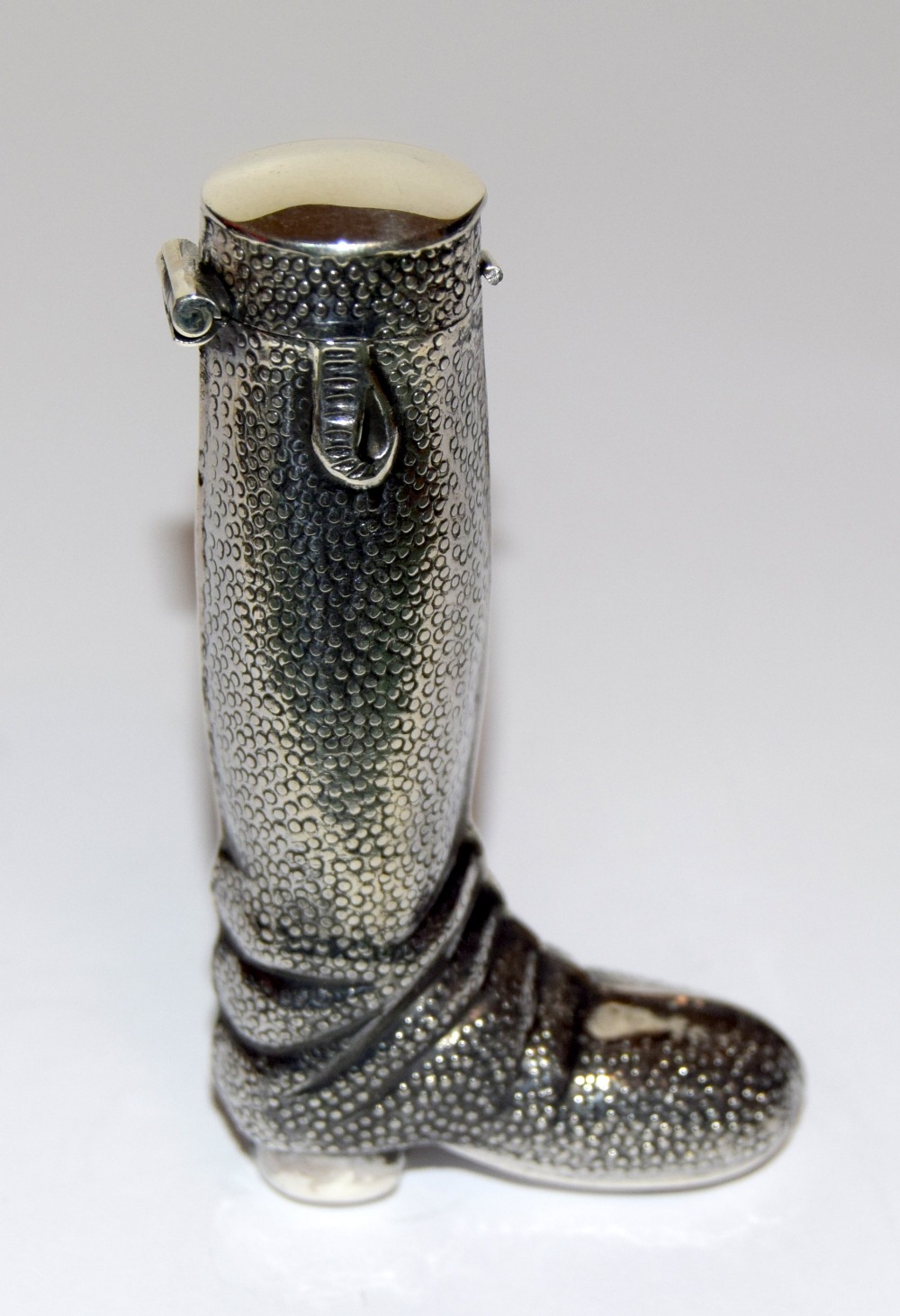 A silver boot vesta case