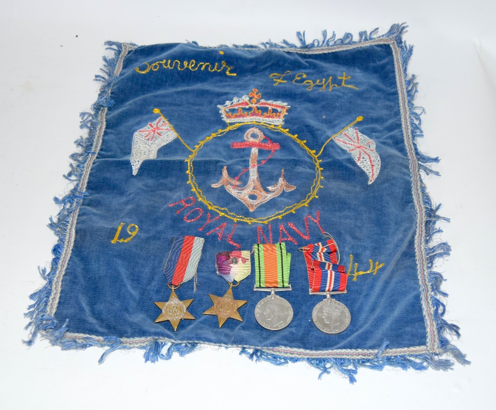 A WW2 Royal Navy medal group of four including the Atlantic Star with a souvenir embroidery of Egypt