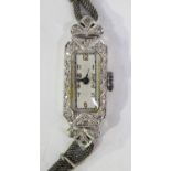 A platinum cased and diamond set lady's rectangular dress wristwatch, with a jewelled Swiss lever