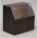 A George III mahogany diminutive bureau, the fall front revealing pigeonholes above five drawers,