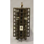 An Edwardian walnut revolving shopkeeper's postcard display stand with a turned finial and cast iron