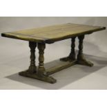 A 20th century oak refectory table, the rectangular top raised on turned supports and bracket feet