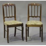 A set of six early 20th century French walnut dining chairs with bobbin turned backs, the