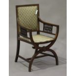 An Edwardian mahogany elbow chair with satinwood crossbanded decoration, the pierced arm supports