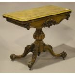 A Victorian walnut fold-over card table, the carved frieze above a turned and reeded baluster