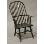 A 19th century ash stick back Windsor armchair, the hoop back above a solid seat, on turned legs