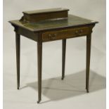 An Edwardian mahogany lady's writing table with crossbanded and line inlaid decoration, fitted