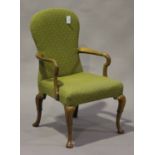 An early 20th century Queen Anne style walnut elbow chair with upholstered seat and back, on