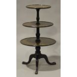 A Victorian mahogany three-tier dumb waiter, the graduating levels on a central turned stem,