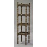 A 20th century oak four-tier whatnot with turned and block supports, height 210cm, width 50cm, depth