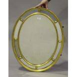 An early 20th century gilt framed oval sectional wall mirror, 83cm x 62cm.Buyer’s Premium 29.4% (