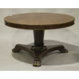 An early Victorian figured mahogany tip-top circular breakfast table, raised on a tapering octagonal