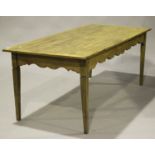 A 19th century French pine farmhouse table, the rectangular top above a shaped frieze, on square