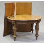 A mid-Victorian mahogany extending dining table, fitted with two extra leaves, raised on turned