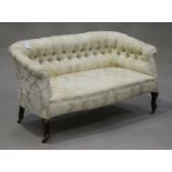 An Edwardian two-seat salon settee, upholstered in buttoned cream damask, height 70cm, width