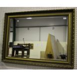 A modern gilt composition rectangular wall mirror with bevelled plate, 80cm x 109cm.Buyer’s