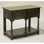 An 18th century and later oak side table, fitted with two frieze drawers, on turned legs united by