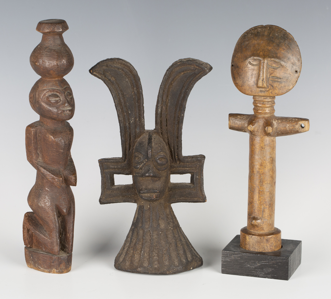 An Ashanti Akan Aku'ba fertility figure, typically modelled with small flattened head and ring