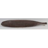 An Australian aboriginal carved hardwood woomera spear thrower, probably early 20th century, one