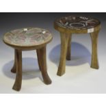 Two East African carved wooden Kamba stools, Kenya, the circular seats with inset beaded decoration,