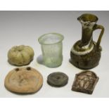 A small group of artifacts, including a Syrian glass beaker, height 6.8cm, an earthenware spindle