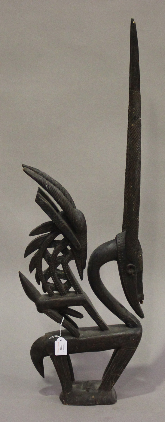 A Bamana Chiwara carved hardwood headdress, Mali, modelled vertically as two stylized antelopes,