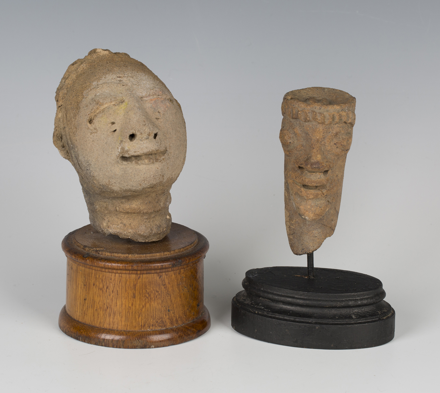 An Ashanti/Akan terracotta 'memorial' head, height 10.5cm, mounted on an oak plinth, together with