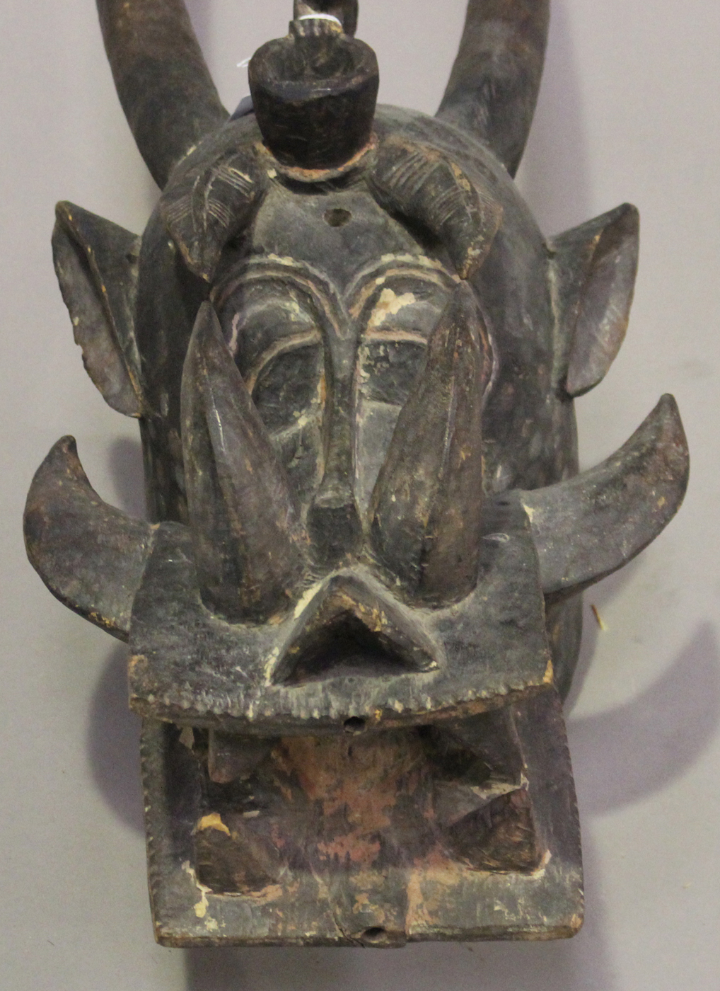 A Senufo Kponyungo carved and painted helmet mask, Ivory Coast, modelled typically in the form of - Image 2 of 4